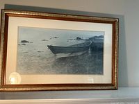 Full view of framed print displaying boat scene, mat and frame visible