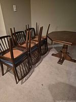 Dining chairs stacked upside down beside table