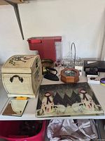 Lot overview with coffee maker, wooden chest, glass boards, brass bowl, metal rack, mirror, sailboat display