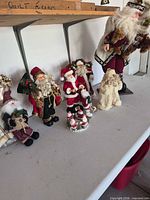 Group view of all Santa and winter figures on table