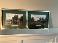 Front view of both framed prints showing artwork, frames and mats