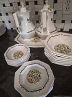 Group shot showing two lidded pots, tray underneath, stacks of small and large octagonal pieces