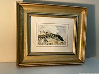 Front view showing framed Richard Tugwell print, matting, gold frame
