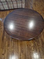 Top view of round dark brown wood veneer coffee table