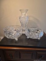 Group shot showing all three crystal pieces: vase, bowl, footed bowl