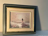 Full view of framed painting hung on wall