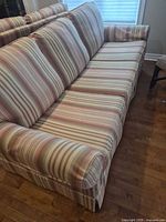 Full view of striped three-seat sofa