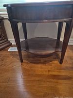 full view front of dark brown veneer end table showing drawer and lower shelf