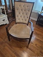 Front view showing tufted back, wood frame, seat cushion