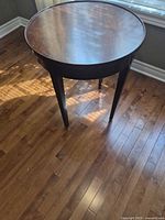 Full view of round side table showing top and legs