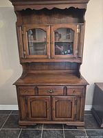 Full view of hutch showing upper glass-door section, lower drawer and cabinet