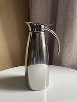 Full view of stainless steel insulated pitcher standing upright