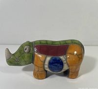 Full side view of glazed rhinoceros figurine