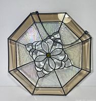 Front view of octagonal stained glass panel with chain