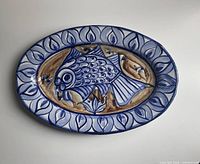 Full top view of oval platter showing fish motif and border
