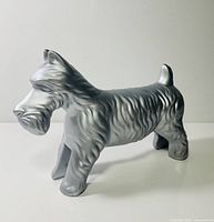 Right side full view of metallic silver dog coin bank