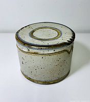 Closed jar showing glaze, decorative rings on lid