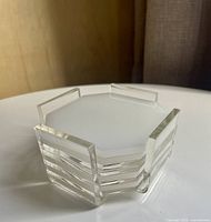 Stacked coasters in holder showing overall set