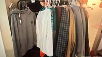 Overall rack with multiple men’s tops and outerwear