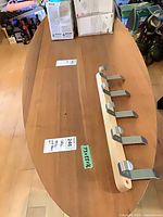 Top view of oval walnut coffee table with hanger placed on surface