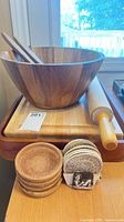 Group view of bowl, servers, cutting board on tray, rolling pin, two coaster stacks