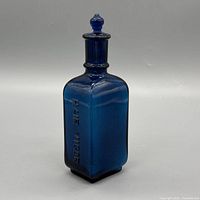 Front view showing "HAIR VIGOR" embossing and stopper fitted