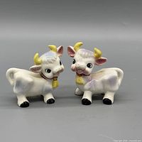 Front view of both ceramic cow shakers