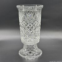 Full view of crystal hurricane vase on pedestal showing shape and cut pattern