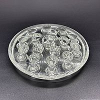 Top view of round clear pressed glass flower frog displaying concentric arrangement of stem holes