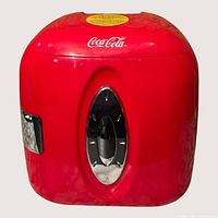 Front view of red Coca-Cola mini cooler showing logo and chrome door accent