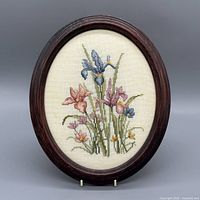 Front view showing entire oval framed embroidery
