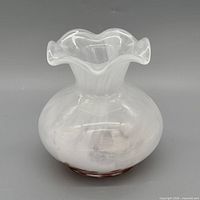 Front view of opalescent glass vase showing ruffled rim and bulbous body