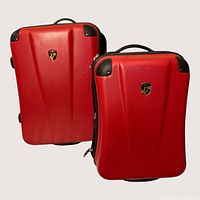 Two red Heys hardside suitcases front view