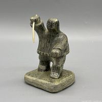 Front view of Inuit hunter sculpture showing spear and overall form