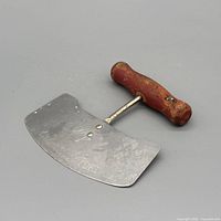 Overall view of mezzaluna showing blade and handle