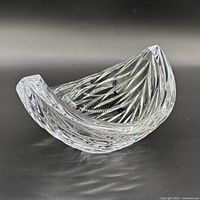 Front angled view showing crescent shape and cut pattern
