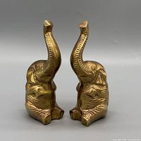Front angled view of both brass elephant figurines