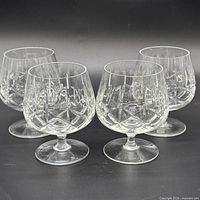 Front view of all four crystal brandy snifters showing diamond cut pattern