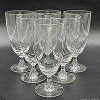 Group of six clear glass goblets showing quantity and overall condition