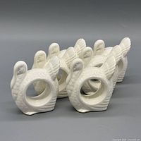 All six white ceramic turkey napkin rings grouped