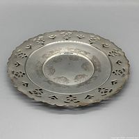 Front view showing engraved pattern and pierced rim