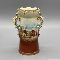 Front view showing full hunting scene, scalloped rim, handles, terracotta lower body