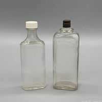 Front view of both bottles showing shape and caps