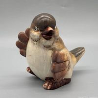 Front left view of ceramic bird figurine showing coloration and glaze