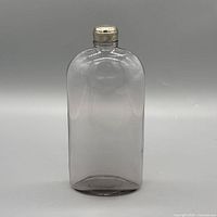 Front view of glass flask highlighting amethyst tint and cap