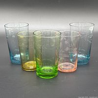 Front view of five colored etched tumblers