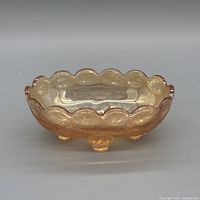 Front view of peach iridescent footed compote showing pattern and feet