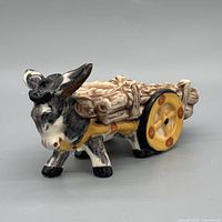 Left front three-quarter view of ceramic donkey cart planter