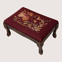 Oblique view of footstool showing top pattern and leg shape