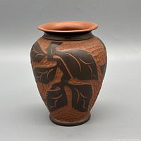 Front view of terracotta vase showing carved floral motif